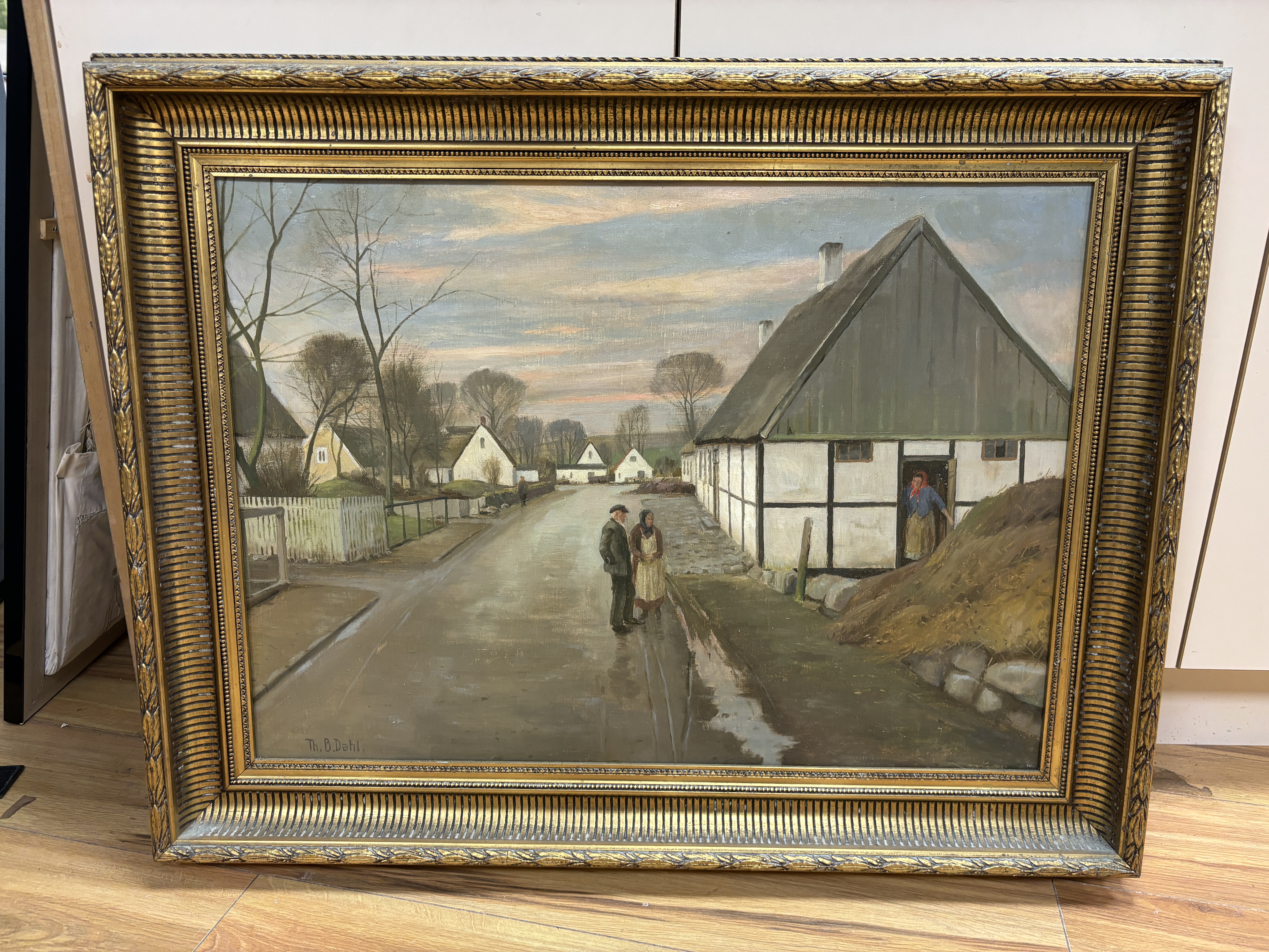 Theodore Dahl (1886-1971), oil on canvas, Street scene with cottages and figures, signed, details verso, ornate gilt framed, 50 x 70cm